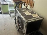 a bike that is parked next to a bike with a box on the back