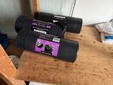a pair of binoculars sitting on top of a wooden table