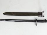 two knives are laying on a white surface next to each other