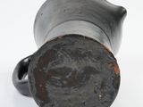 a close up of a metal object on a white surface