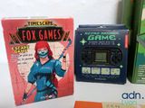 a box of games and a game controller on a table