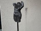 a statue of a bear that is on a pole