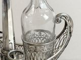 a silver tray with a glass bottle and a knife on it
