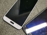 three cell phones are laying on the floor next to each other