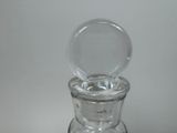 a clear glass bottle with a clear lid on a table