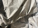 a bed with a white sheet and a pillow on top of it