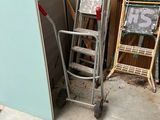 a ladder that is next to a pile of wood