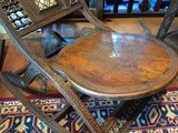 an image of a wooden folding chair on a rug in a room