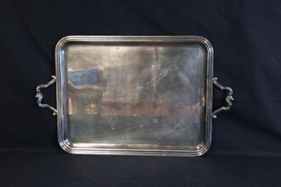silver plated serving tray with handles and handles on a black background