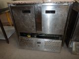 a picture of a stainless steel refrigerator in a kitchen