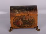 an old wooden box with a painting on it sitting on a table