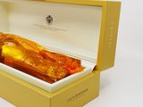 a bottle of whisky in a box on a white surface