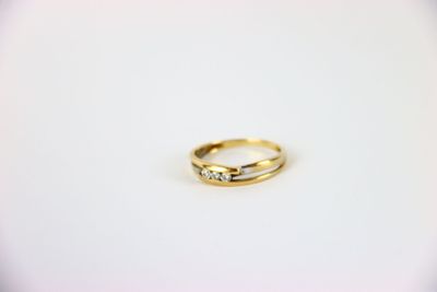 a close up of a wedding ring on a white surface