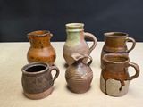 four different types of vases sitting on a table