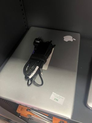 two laptops that are sitting on a shelf in a store