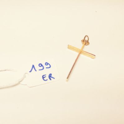 a close up of a cross and a tag on a white surface