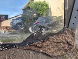 someone is taking a picture of a broken window with their cell phone