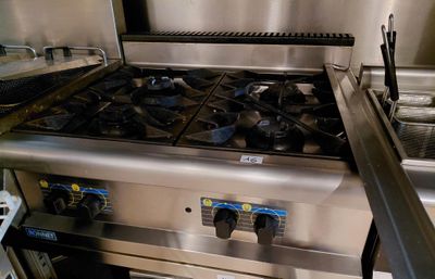 a stainless steel stove and oven in a commercial kitchen
