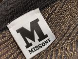 a close up of a black and gold jacket with a missoni label