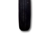 a close up of a car tire on a white surface