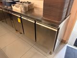 stainless steel counter top in a commercial kitchen with pots and pans on it