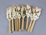 six wooden spoons with different designs on them on a table