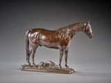 bronze statue of a horse standing on top of a pile of rocks