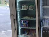 two refrigerators that are sitting next to each other in a room
