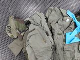 a pile of military clothing on a metal surface