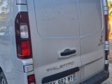 a silver van that is parked on the side of the road