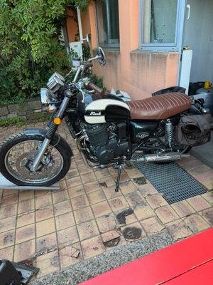 a motorcycle that is parked in front of a house