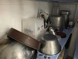 pots and pans sit on a stove in a kitchen
