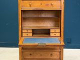 an old wooden desk with a blue top and drawers