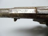 a close up of a gun on a white surface
