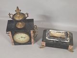 two clocks sitting next to each other on a table
