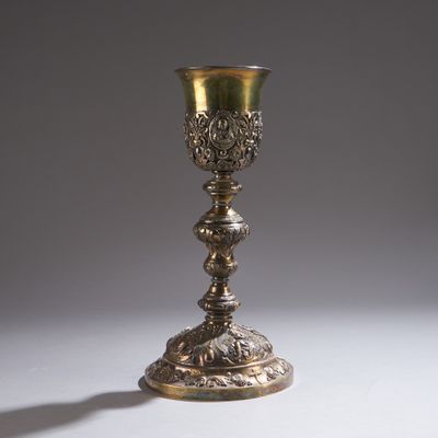 a silver cup that is sitting on a table
