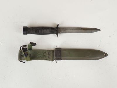 two knives are laying side by side on a white surface