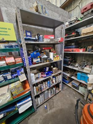 many shelves with various items on them in a room