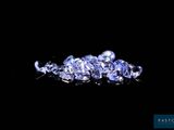 a close up of a bunch of blue sapphires on a black surface