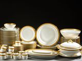 a lot of plates and bowls that are sitting on a table