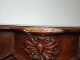 a close up of a wooden table with carvings on it