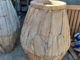 two wooden vases sitting next to each other on a bench