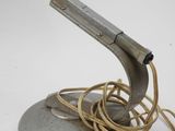 a metal object with a cord on top of it