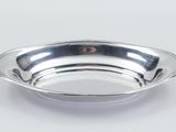 a close up of a silver plate on a white background