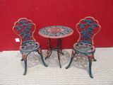two chairs and a table on the floor in front of a red wall