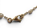 an image of a close up of a necklace on a white background