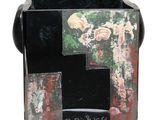 a black vase with a picture of a cross on it