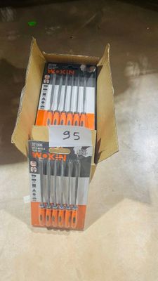 a lot of pens in a box on the floor