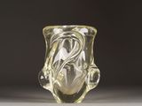 a clear glass vase with a swirly design on it