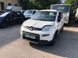 a small white car that is parked in a parking lot